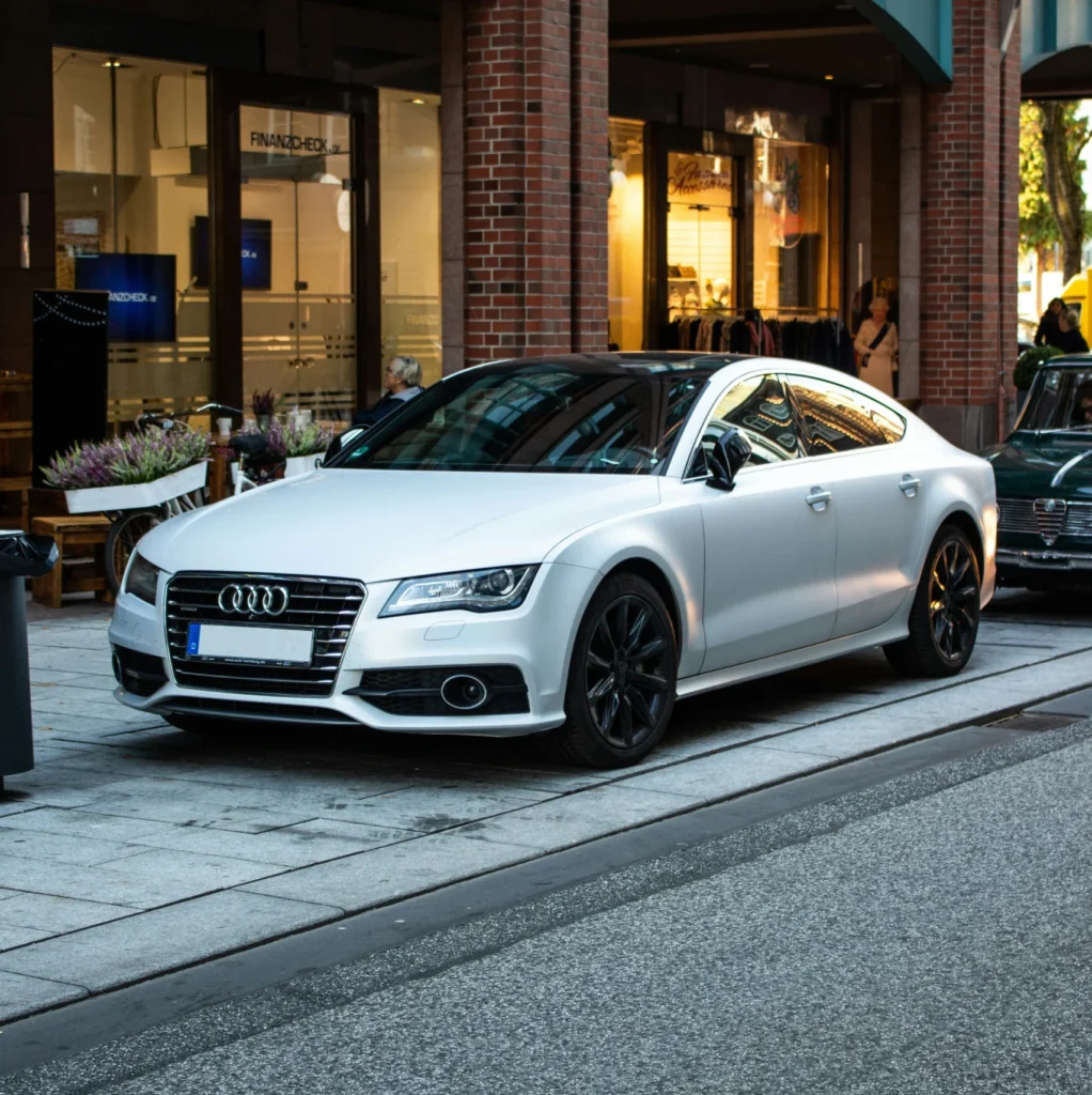 White executive saloon parked outside a hotel